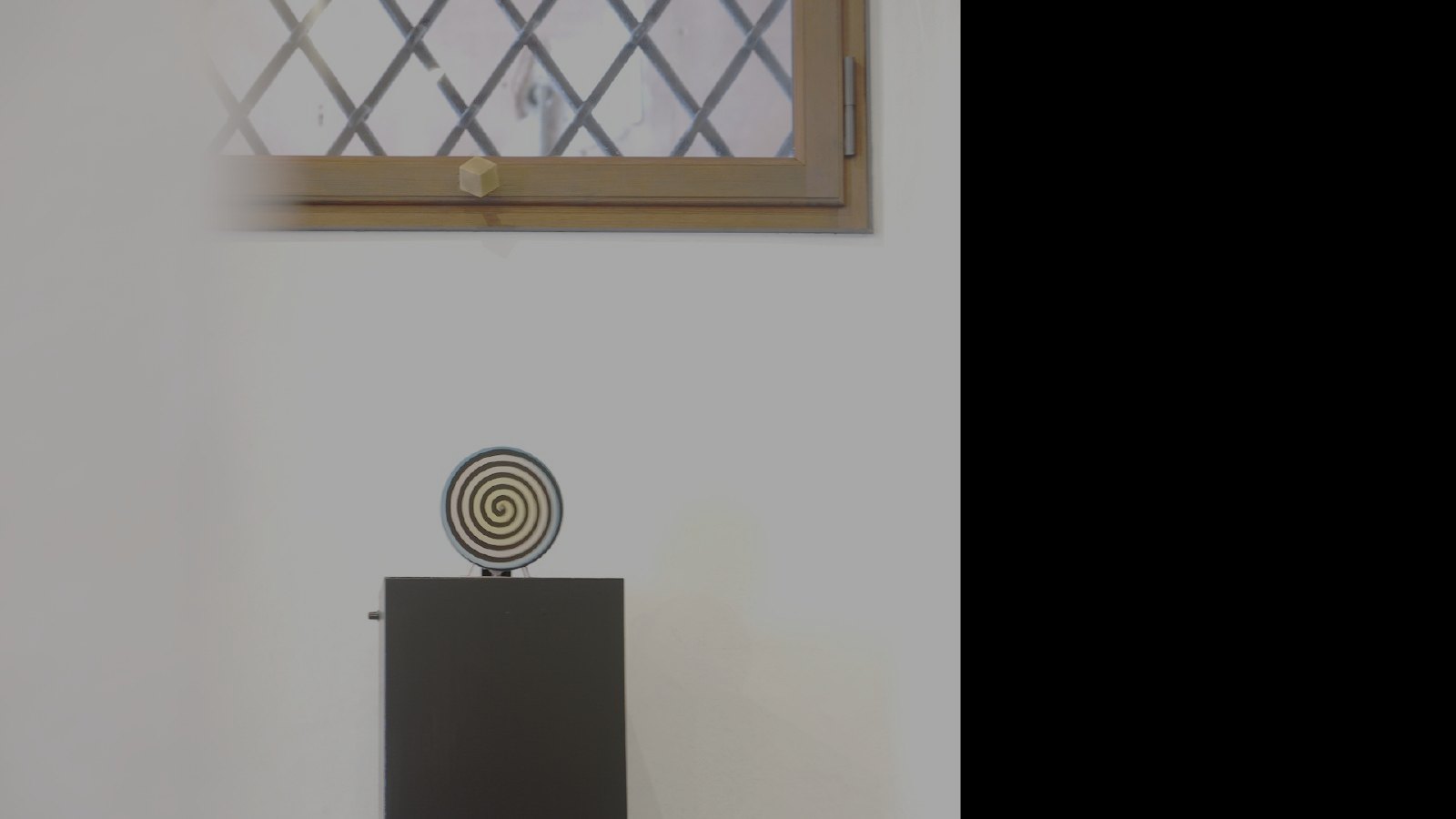 A rotorelief disc spinning on a plinth in the gallery