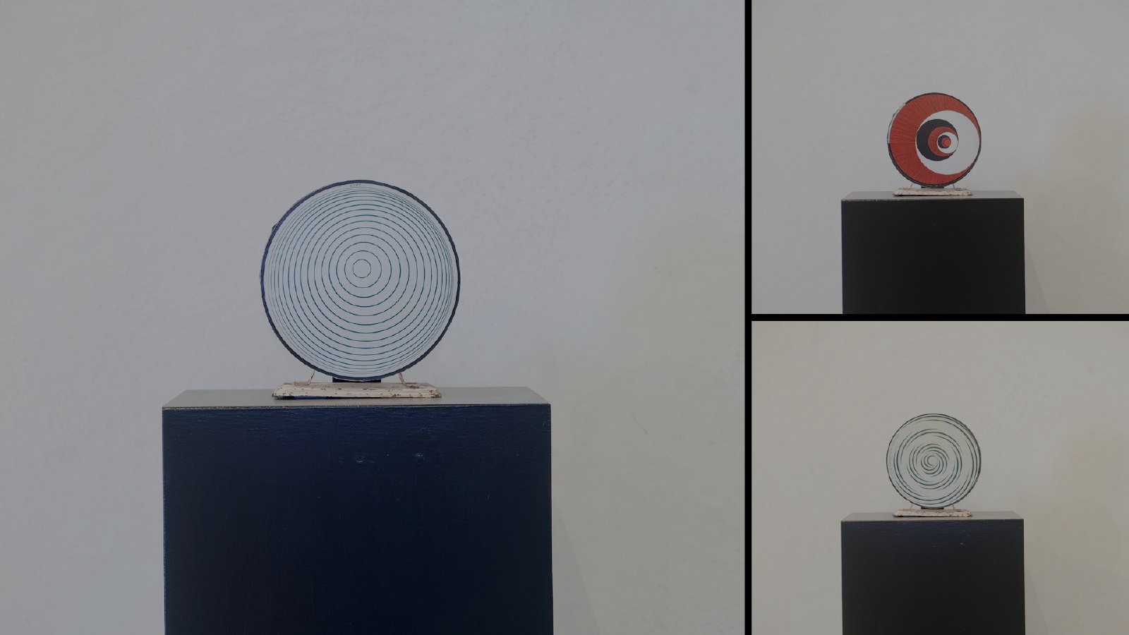Three rotorelief discs mounted on black plinths in a gallery